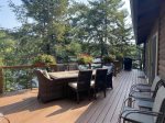 Beautiful outdoor deck with dining furniture overlooking the water